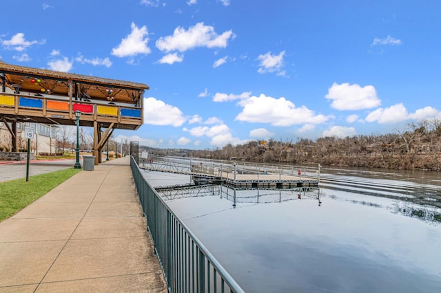 view of property's community with a dock and a water view