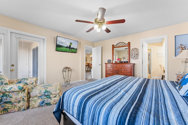 bedroom with carpet floors, a ceiling fan, and a textured ceiling