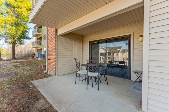 view of patio featuring outdoor dining space and cooling unit