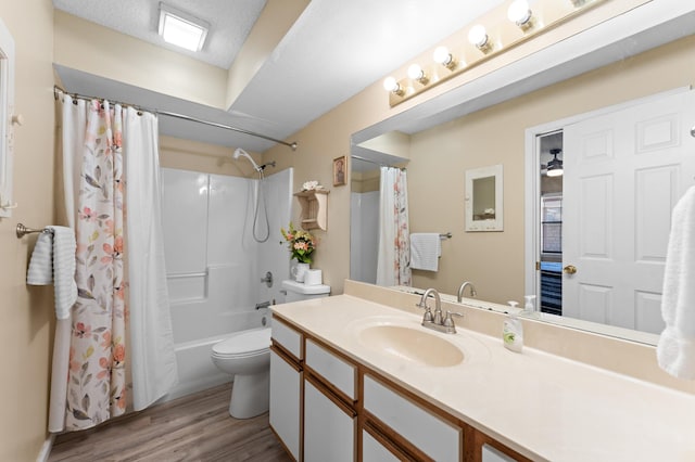 full bathroom with vanity, wood finished floors, toilet, and shower / tub combo with curtain