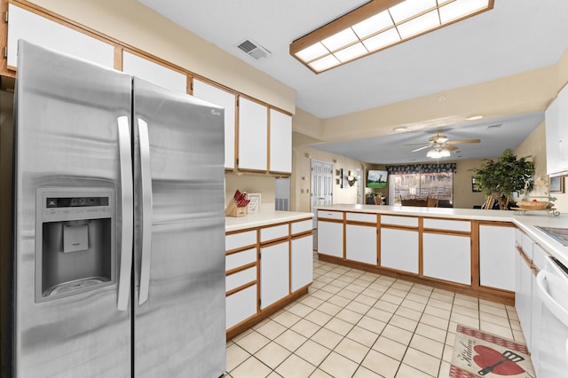 kitchen featuring light tile patterned flooring, white cabinetry, light countertops, stainless steel refrigerator with ice dispenser, and dishwasher