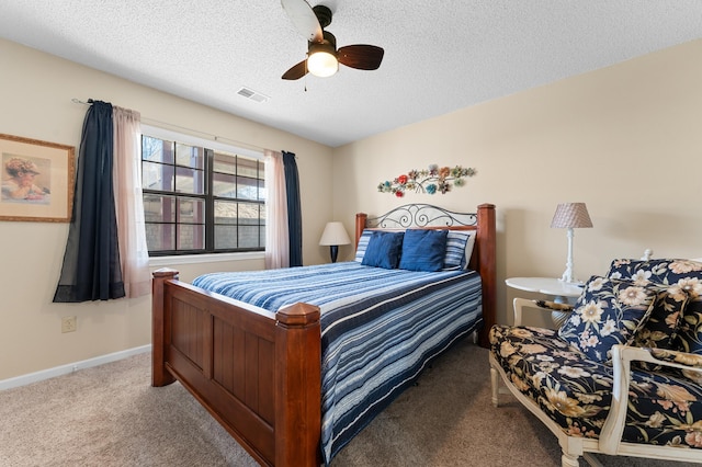 carpeted bedroom featuring a textured ceiling, ceiling fan, visible vents, and baseboards