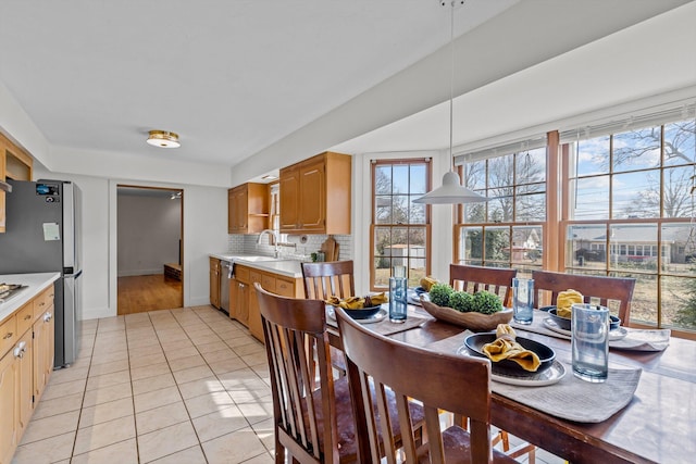 dining room with light tile patterned floors and baseboards