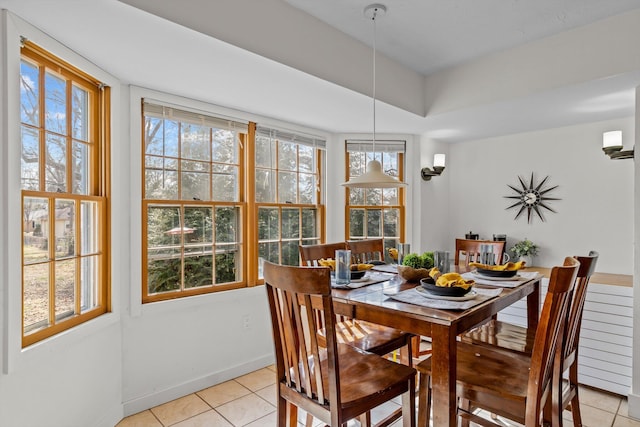 dining room featuring baseboards and light tile patterned floors