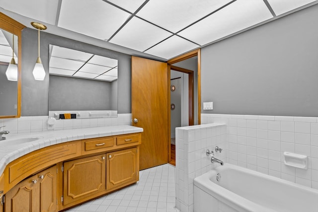 full bathroom featuring vanity, a bath, and tile patterned floors