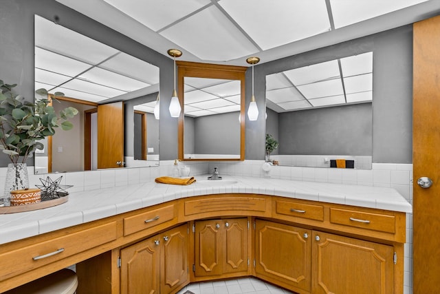 bathroom with a drop ceiling and vanity