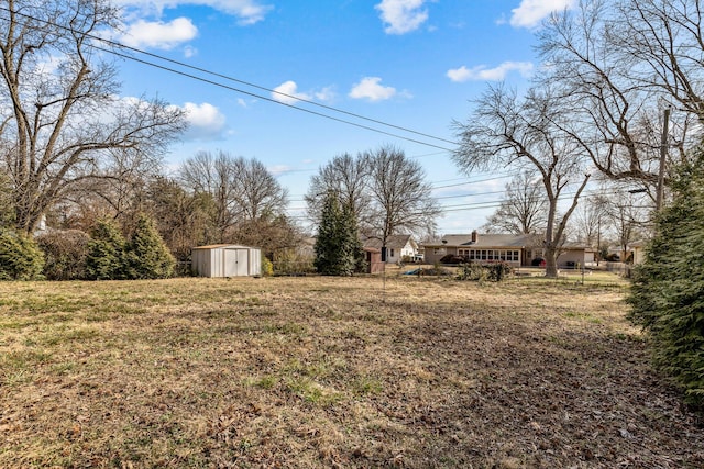 view of yard featuring an outbuilding and a storage shed