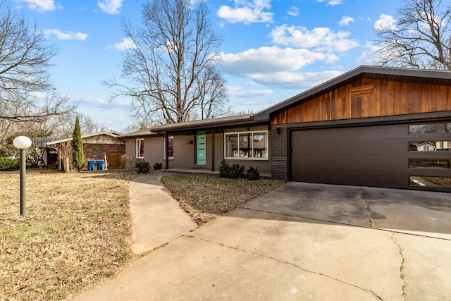 view of front of home featuring concrete driveway, brick siding, and an attached garage