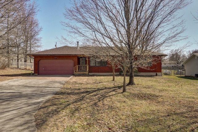 ranch-style house featuring a garage, a front lawn, driveway, and fence