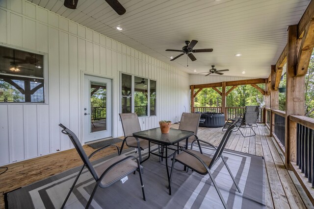 wooden deck featuring a ceiling fan and outdoor dining space