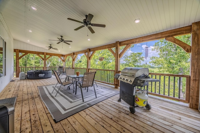 wooden terrace with ceiling fan, outdoor dining area, and a grill