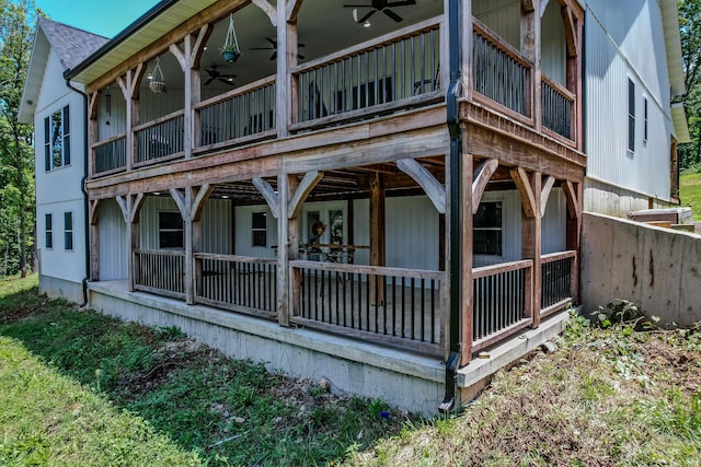 back of property featuring a shingled roof and a ceiling fan