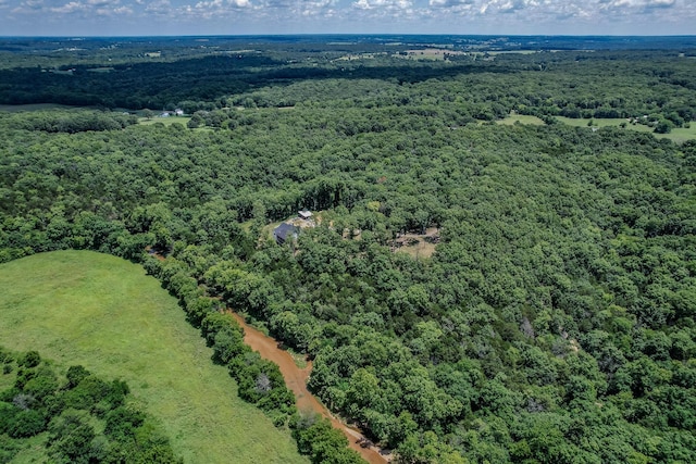 bird's eye view featuring a wooded view