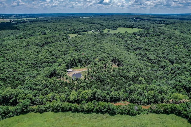 aerial view featuring a wooded view