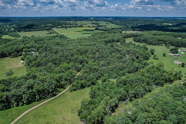 birds eye view of property with a view of trees