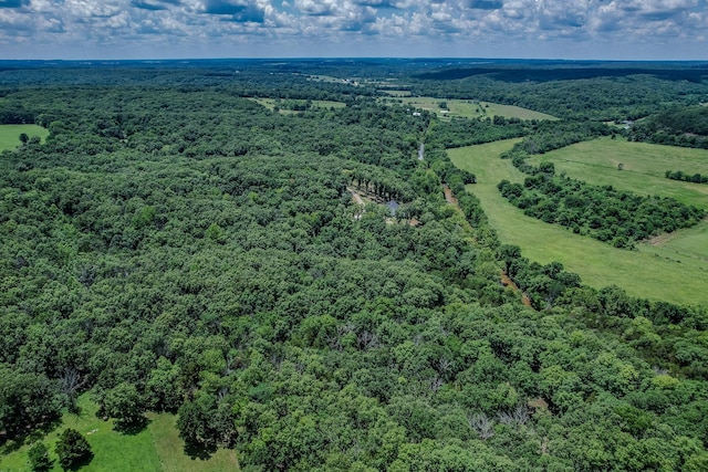 birds eye view of property with a view of trees