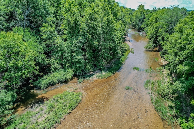 birds eye view of property featuring a wooded view