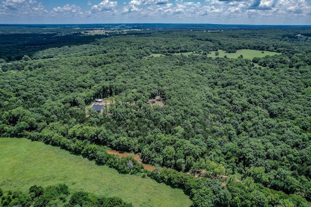 birds eye view of property with a wooded view