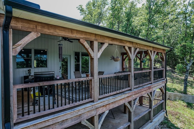 wooden terrace featuring a grill