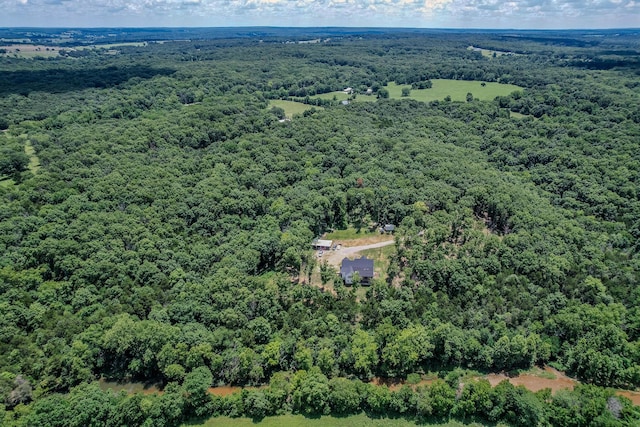 birds eye view of property featuring a wooded view