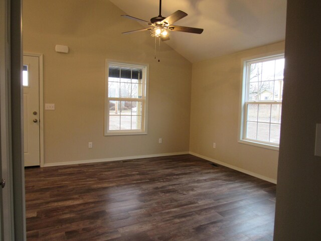 unfurnished room featuring vaulted ceiling, ceiling fan, dark wood-style floors, and baseboards