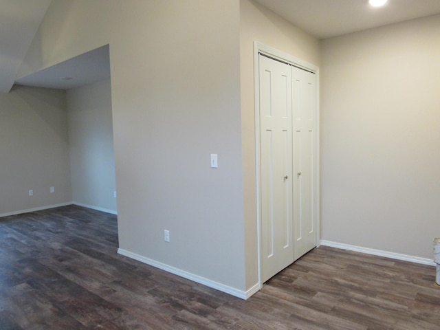 interior space with dark wood-style flooring and baseboards