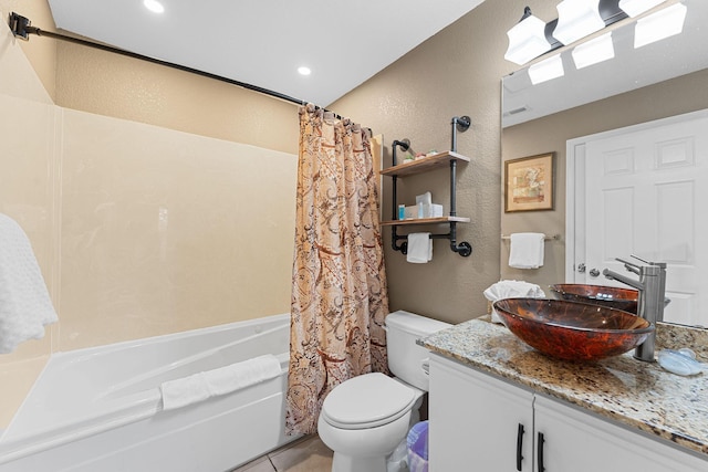 bathroom with shower / bath combination with curtain, toilet, vanity, and a textured wall