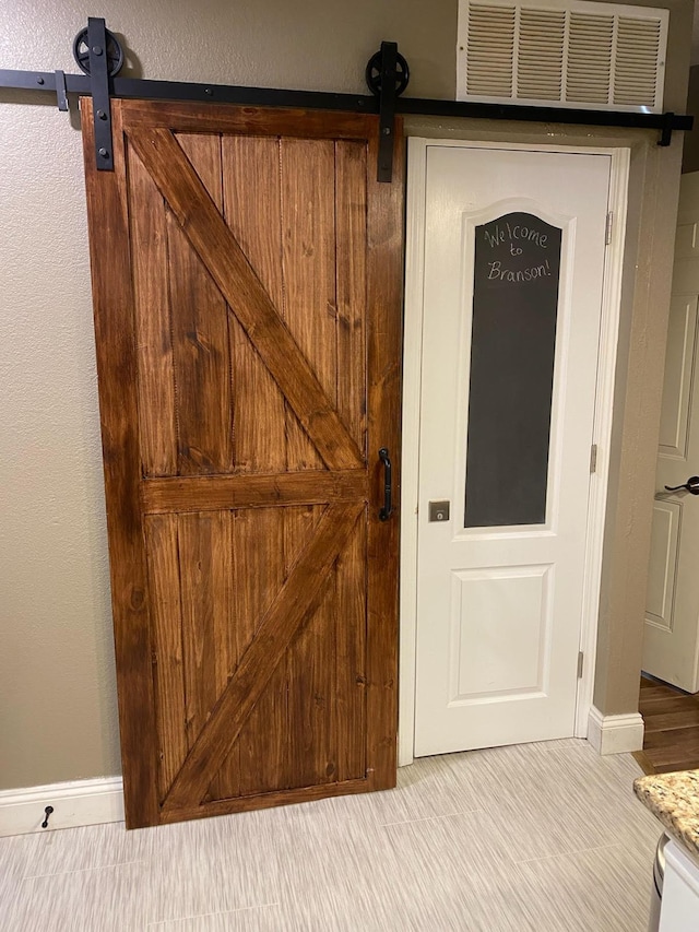 interior details with a barn door and visible vents