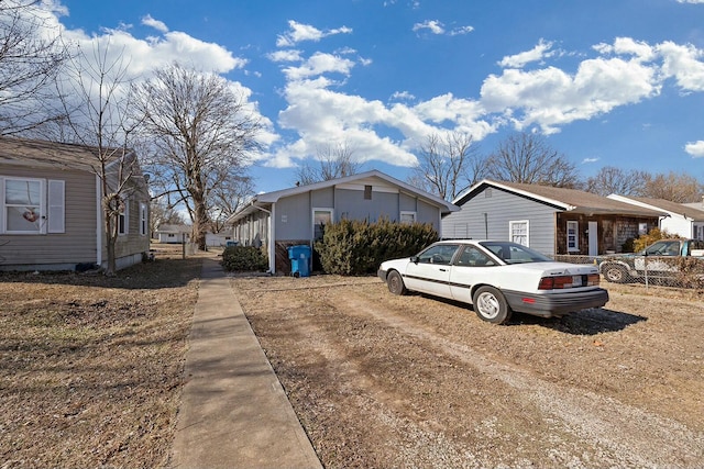 view of front facade featuring a residential view and fence