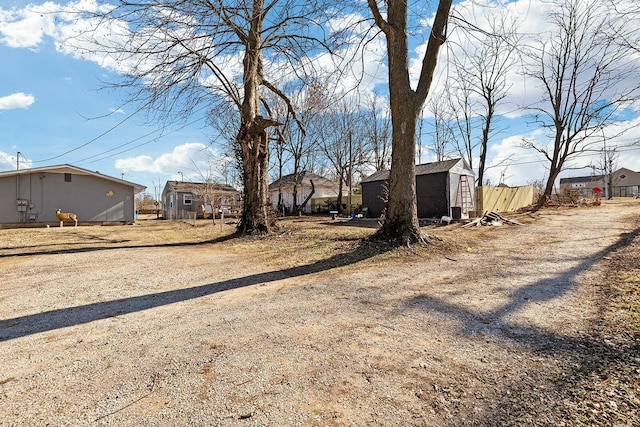 view of yard with a storage unit and an outbuilding