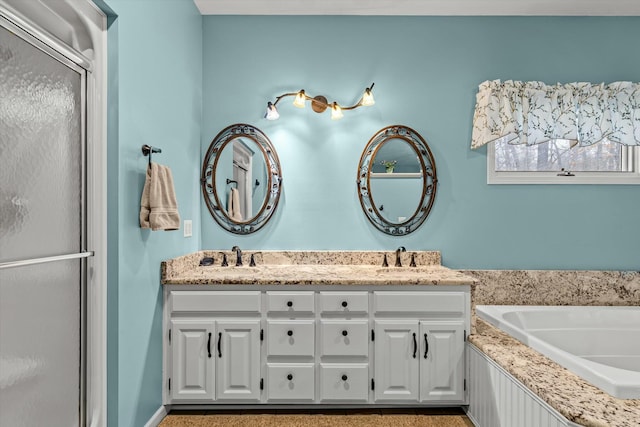 bathroom featuring double vanity, a sink, a bath, and a shower with shower door