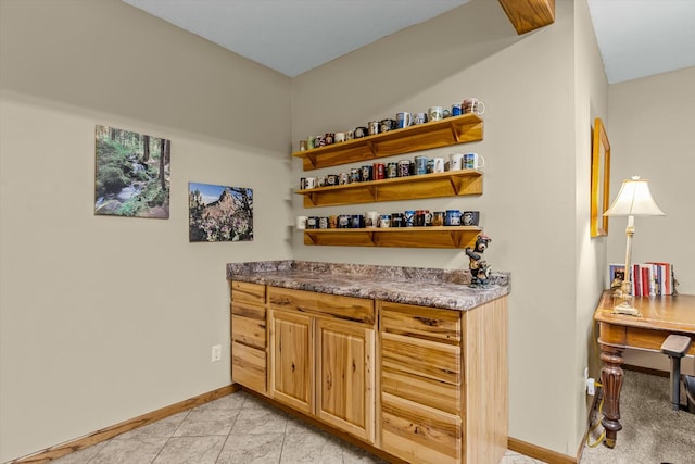 bar with baseboards and light tile patterned floors