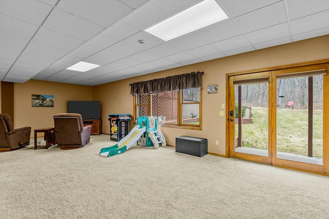 playroom featuring carpet, baseboards, and a drop ceiling