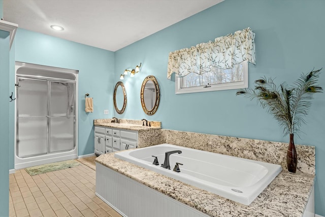 bathroom featuring a sink, double vanity, a shower stall, and a bath