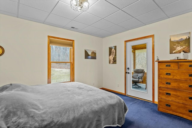 bedroom with a paneled ceiling, baseboards, visible vents, and dark carpet