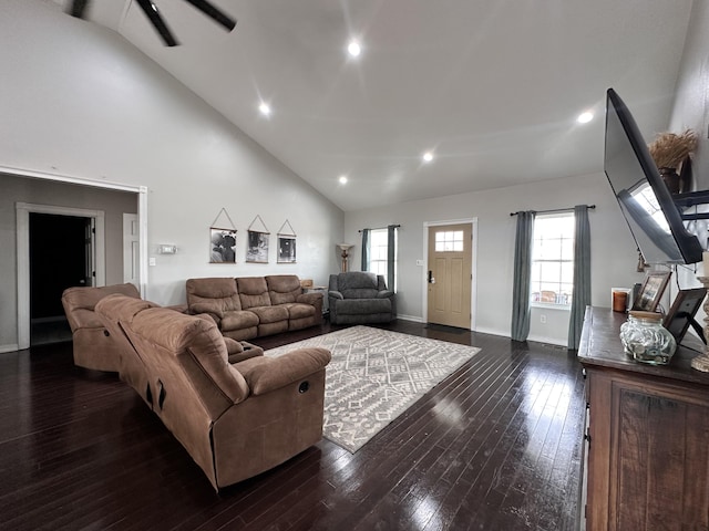 living room with high vaulted ceiling, recessed lighting, dark wood-style flooring, and baseboards