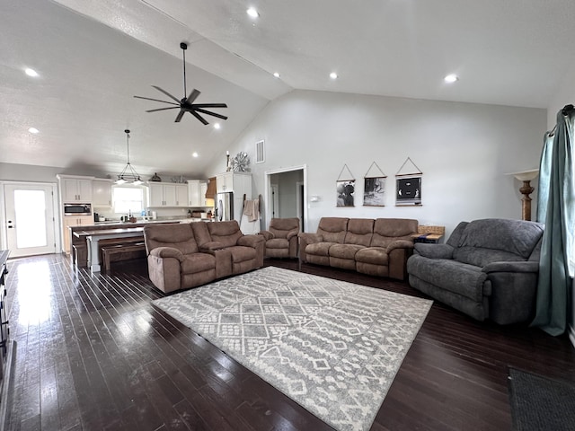 living room with dark wood finished floors, recessed lighting, visible vents, a ceiling fan, and high vaulted ceiling