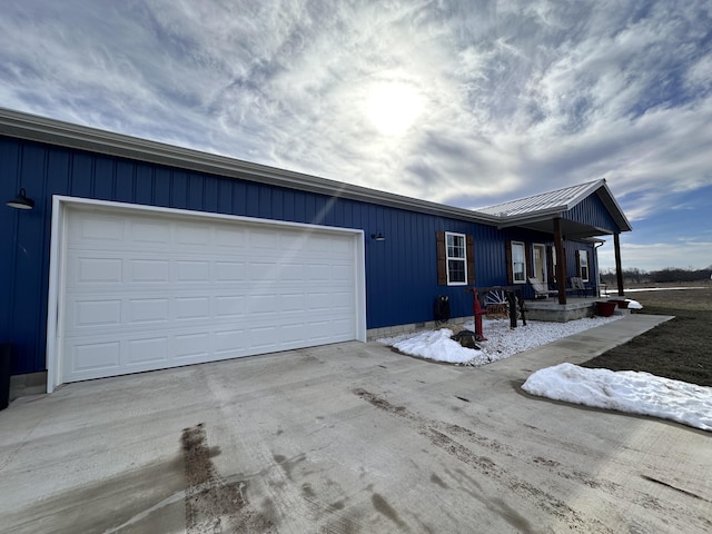 view of front facade with a garage, concrete driveway, and a porch