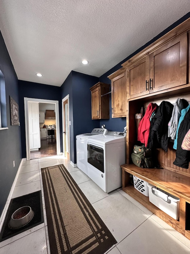 mudroom featuring light tile patterned floors, baseboards, a textured ceiling, washing machine and dryer, and recessed lighting