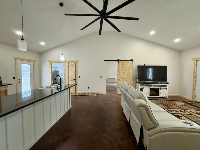 living area with ceiling fan, a barn door, recessed lighting, baseboards, and finished concrete floors