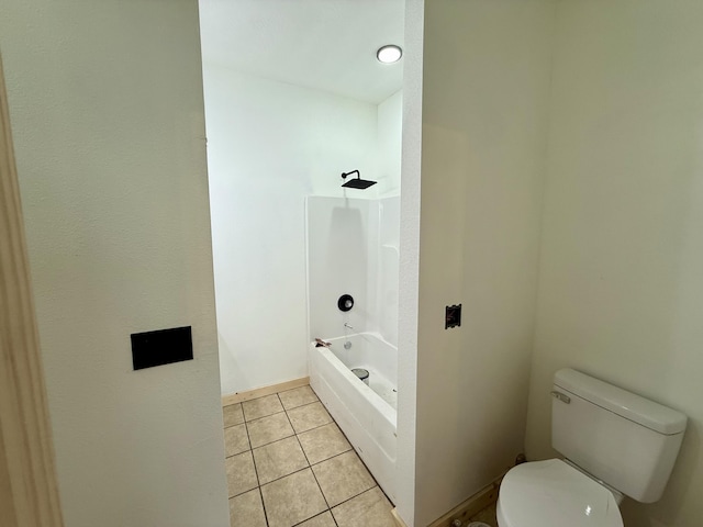 full bathroom featuring toilet, tile patterned flooring, baseboards, and shower / washtub combination