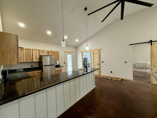 kitchen featuring high vaulted ceiling, freestanding refrigerator, dark countertops, and a barn door