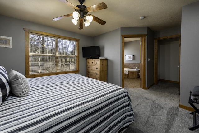 bedroom featuring carpet flooring, connected bathroom, a textured ceiling, ceiling fan, and baseboards