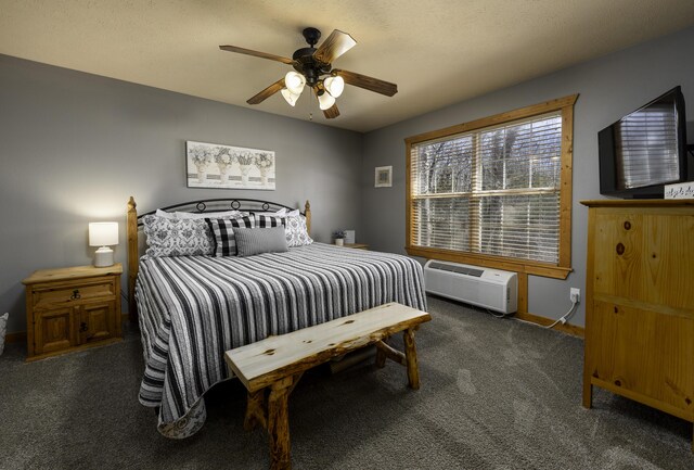 bedroom featuring carpet floors, an AC wall unit, baseboards, and a ceiling fan