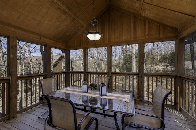 sunroom / solarium featuring a healthy amount of sunlight, wooden ceiling, and vaulted ceiling