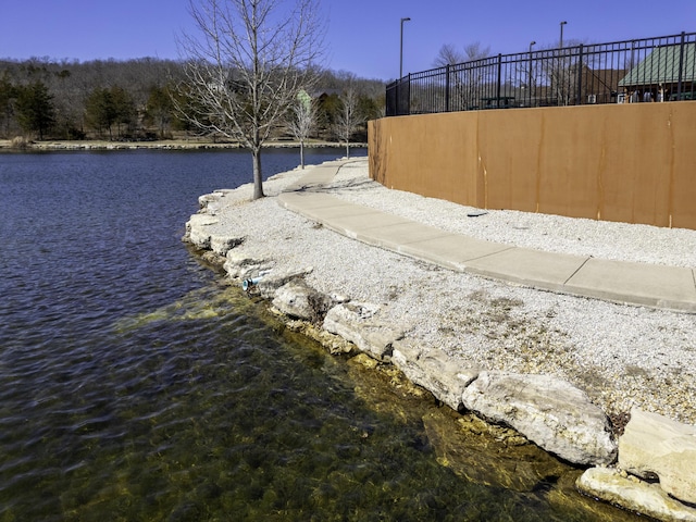 view of yard featuring a water view and fence