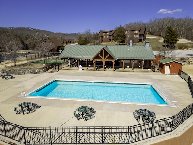 pool with fence, a gazebo, and a patio