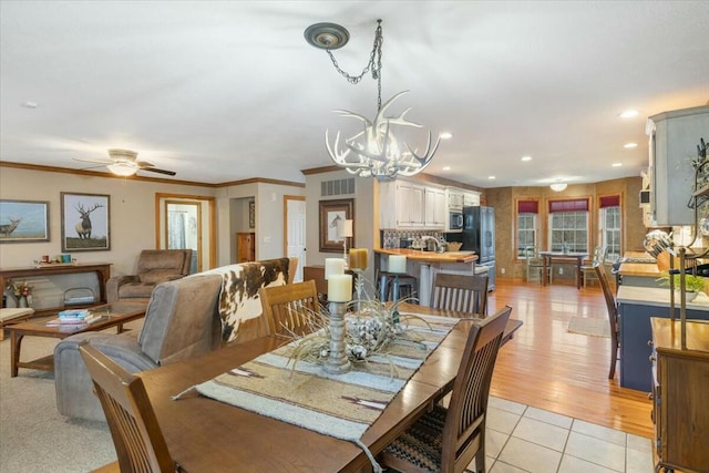 dining area featuring light tile patterned floors, ceiling fan with notable chandelier, recessed lighting, and crown molding