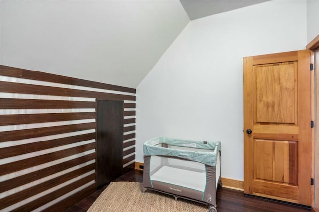 additional living space featuring vaulted ceiling, wood finished floors, and baseboards