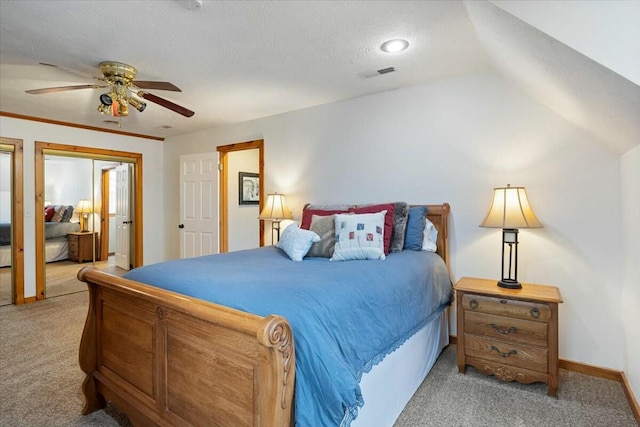 bedroom with lofted ceiling, visible vents, a ceiling fan, and light colored carpet